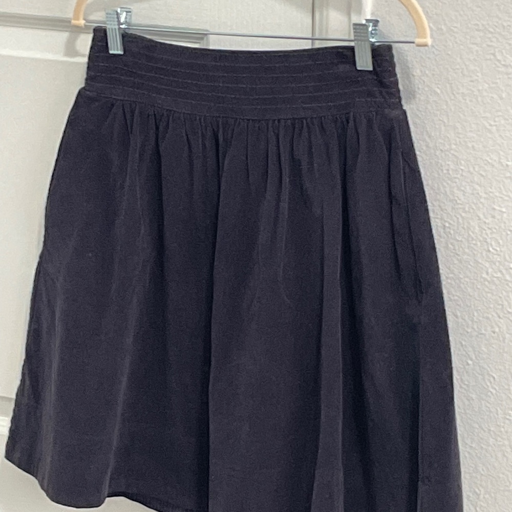 Navy corduroy pleated skirt with pockets.